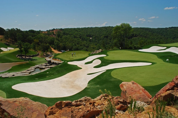 Asheville lush green synthetic grass golf course with white sand bunkers and blue sky